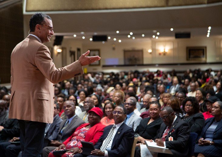 a preacher preaching in front of the congregants